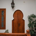 Brown Wooden Door Beside Green Plant